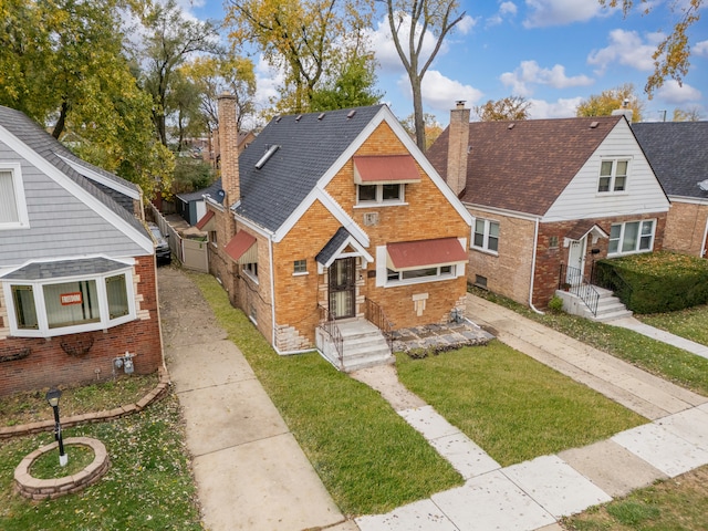 bungalow-style house featuring a front yard