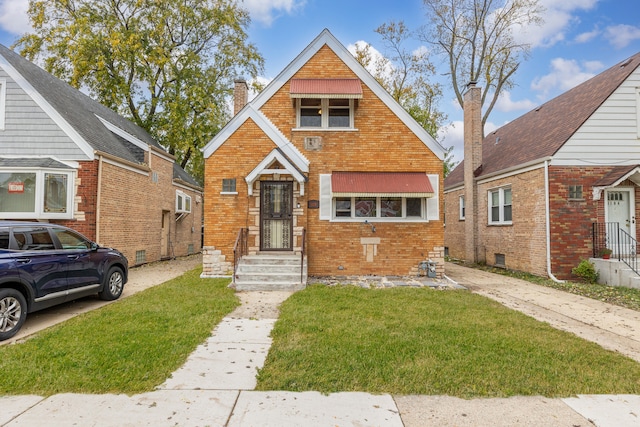 bungalow-style home with a front yard