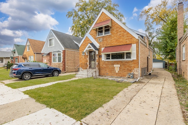 bungalow featuring a garage, an outdoor structure, and a front lawn