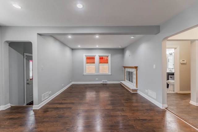 unfurnished living room featuring dark hardwood / wood-style floors