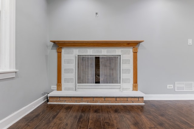 room details with a fireplace and hardwood / wood-style flooring