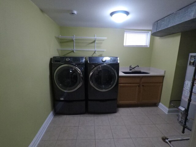 laundry room with cabinets, separate washer and dryer, light tile patterned flooring, and sink