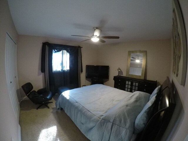 carpeted bedroom featuring ceiling fan and a closet