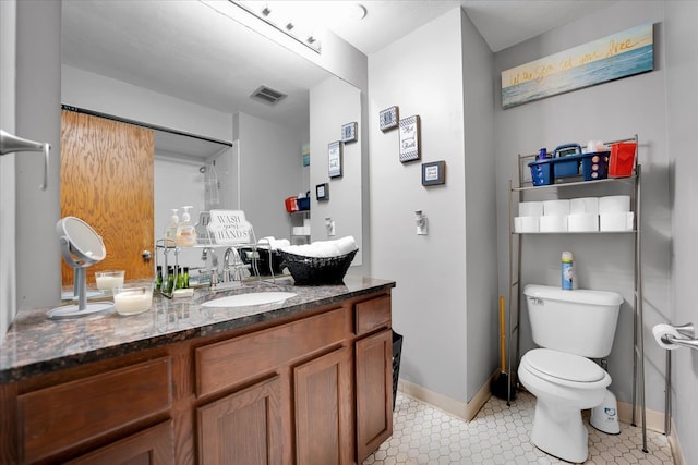 bathroom with vanity, tile patterned floors, and toilet