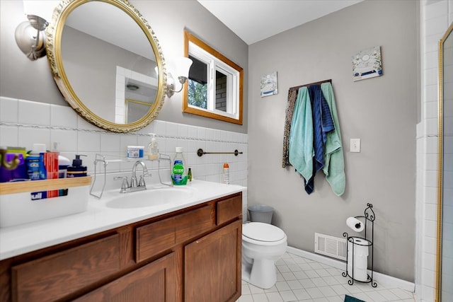 bathroom with toilet, backsplash, vanity, and tile patterned flooring