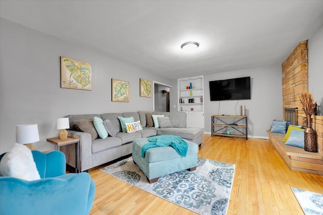 living room with wood-type flooring and built in features