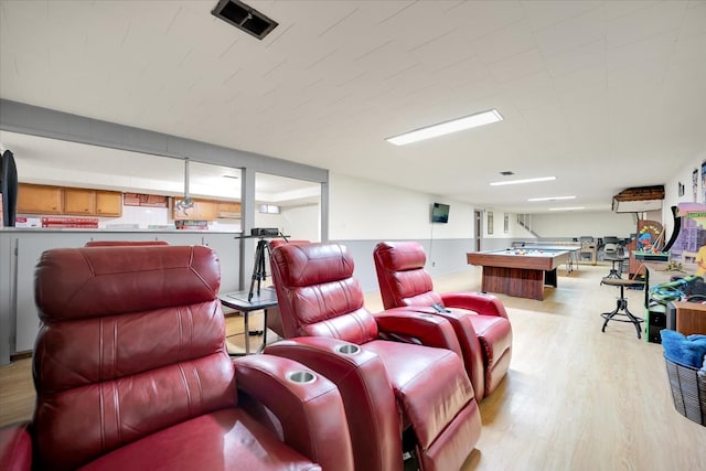 home theater room with billiards and light hardwood / wood-style flooring