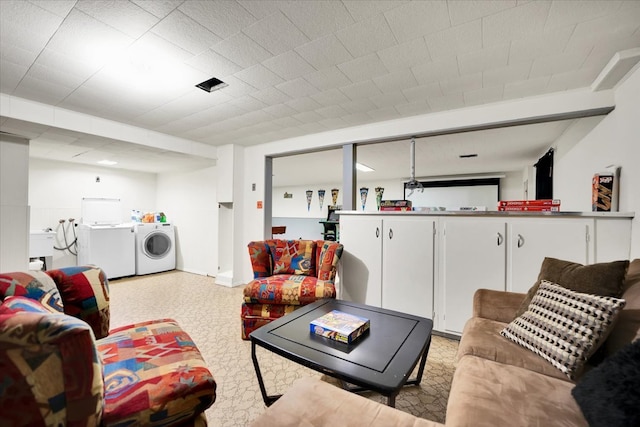 living room featuring washing machine and clothes dryer