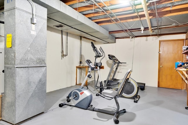 workout room with concrete flooring and heating unit