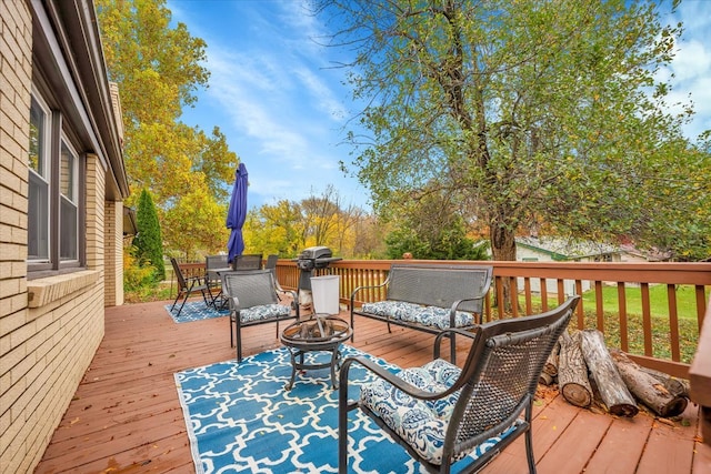 wooden terrace with an outdoor fire pit