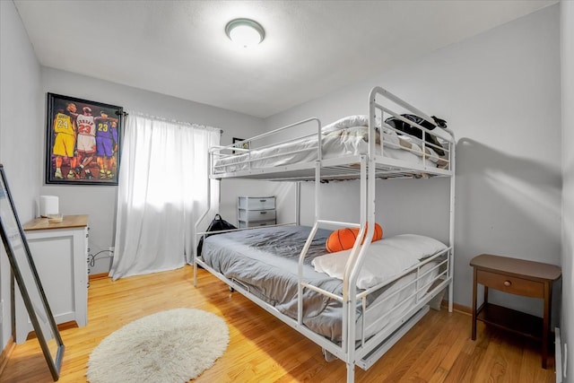 bedroom with hardwood / wood-style floors