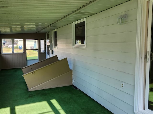 unfurnished sunroom featuring vaulted ceiling