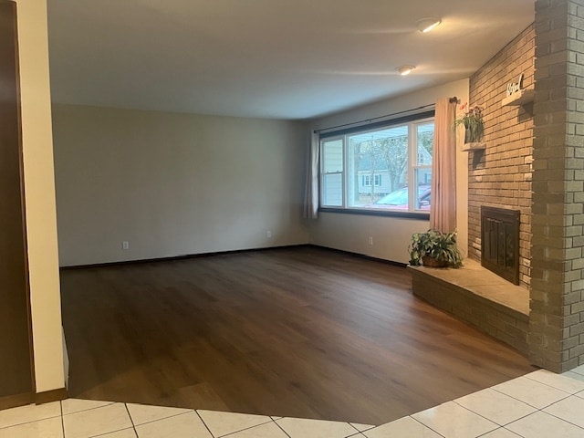 unfurnished living room with a fireplace and light hardwood / wood-style floors