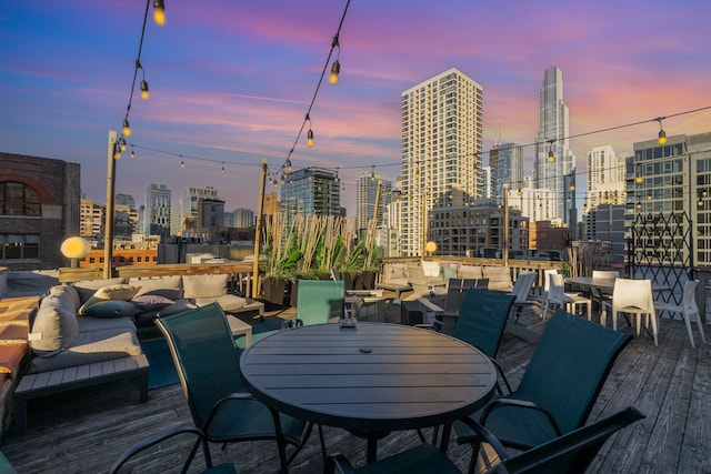 deck at dusk with outdoor lounge area