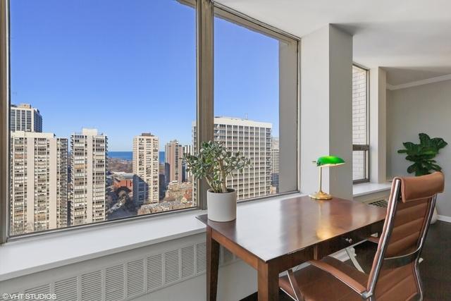 dining room with radiator heating unit, ornamental molding, a city view, and wood finished floors