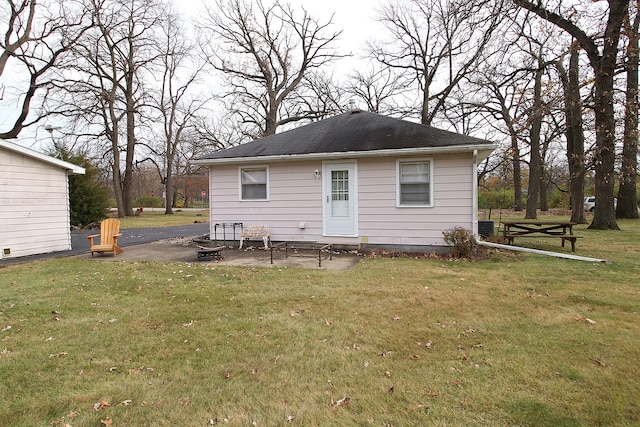 back of house featuring cooling unit and a lawn