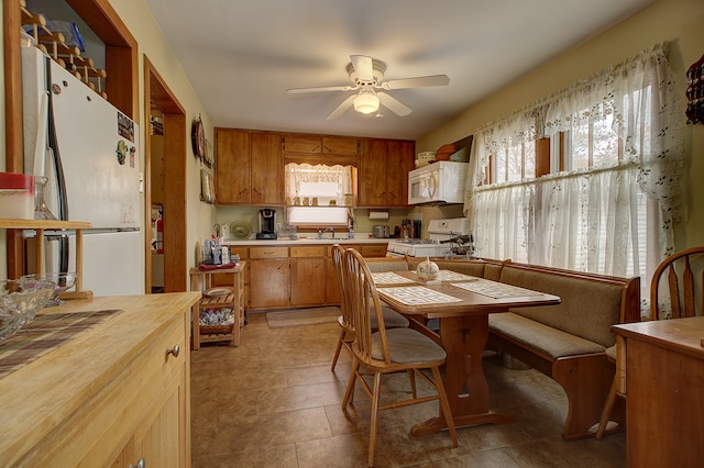 kitchen featuring white appliances, ceiling fan, and sink