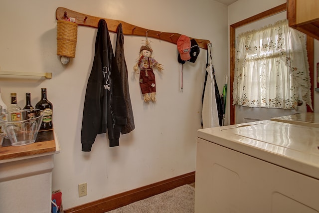 laundry room featuring light colored carpet and washing machine and clothes dryer