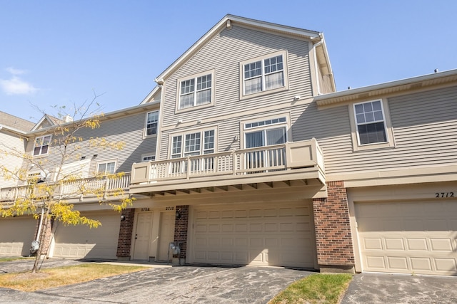 multi unit property featuring a garage and a balcony