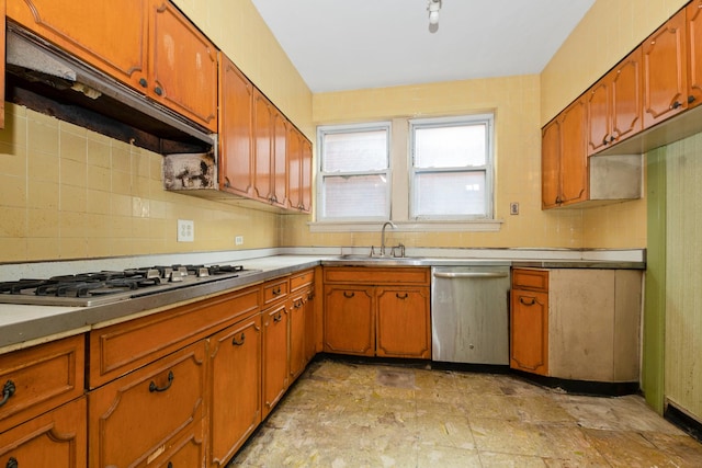 6922 S Jeffery Blvd Unit 3S, Chicago, IL 60649 - kitchen with stainless steel appliances, a sink, under cabinet range hood, brown cabinets, and light countertops
