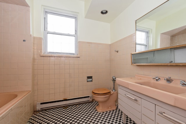 bathroom featuring a baseboard radiator, toilet, a wealth of natural light, and tile walls