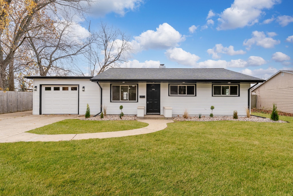 single story home with a front lawn and a garage