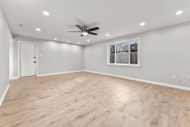 empty room with ceiling fan and light hardwood / wood-style flooring