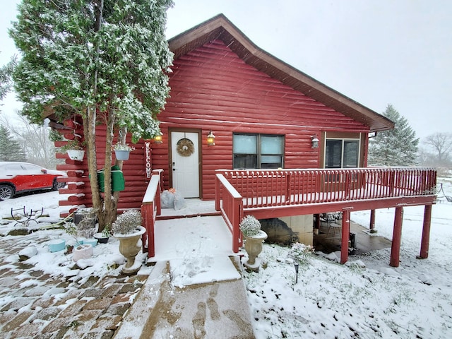 log-style house with a deck