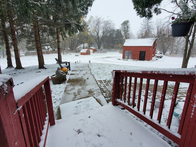 snowy yard featuring an outdoor structure