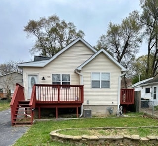 back of house featuring a yard, central AC, and a wooden deck