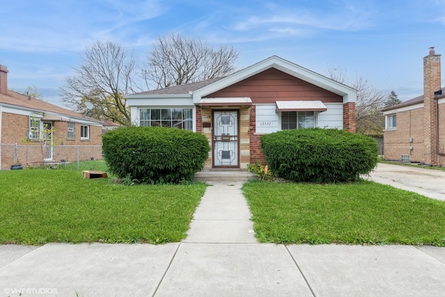 bungalow-style home featuring a front lawn