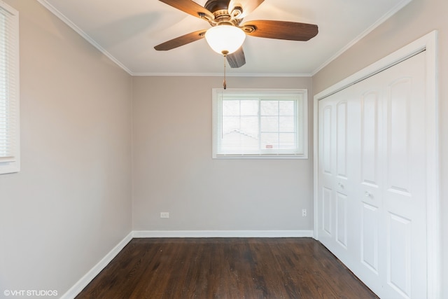 unfurnished bedroom featuring dark hardwood / wood-style flooring, a closet, ornamental molding, and ceiling fan