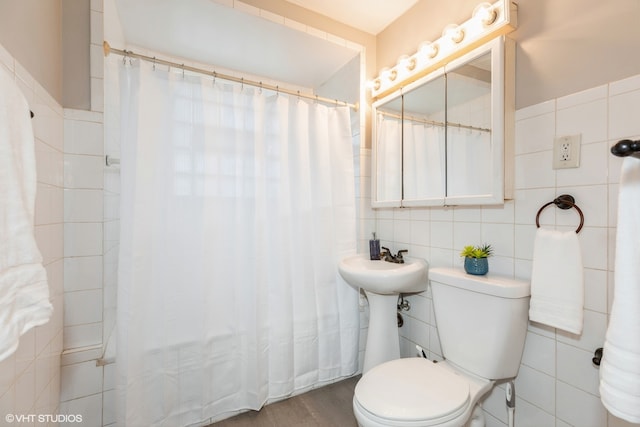 bathroom featuring toilet, tile walls, and hardwood / wood-style flooring