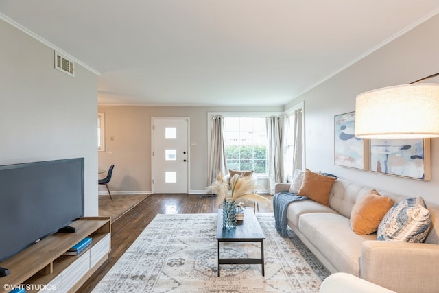 living room featuring ornamental molding and wood-type flooring