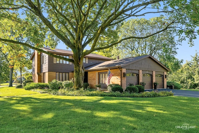 view of front of home with a front yard and a garage