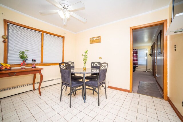 tiled dining space featuring ornamental molding, a baseboard heating unit, and ceiling fan