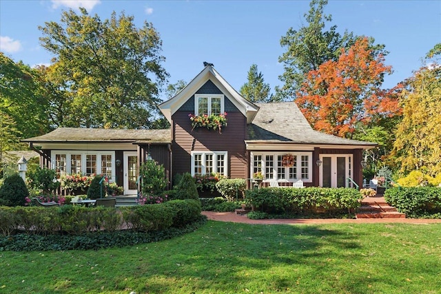 rear view of property featuring french doors and a yard