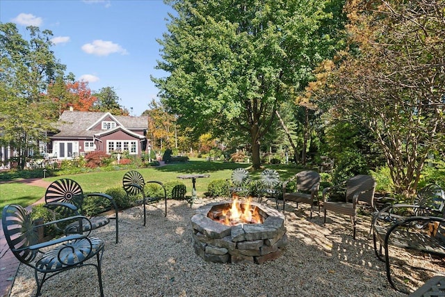 view of yard featuring an outdoor fire pit and a patio