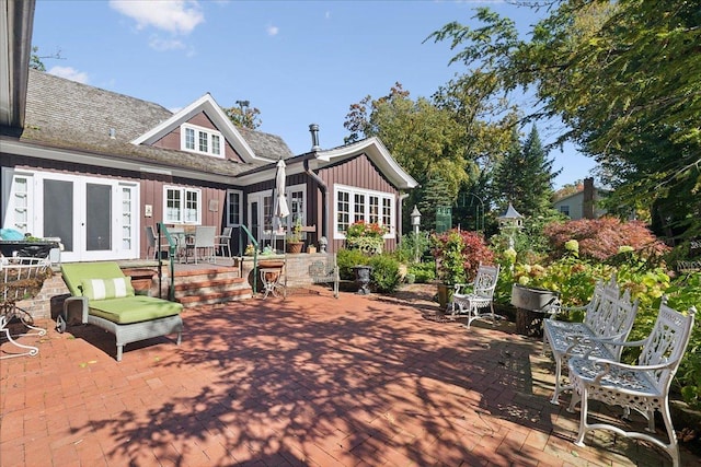 back of property with a patio area and french doors