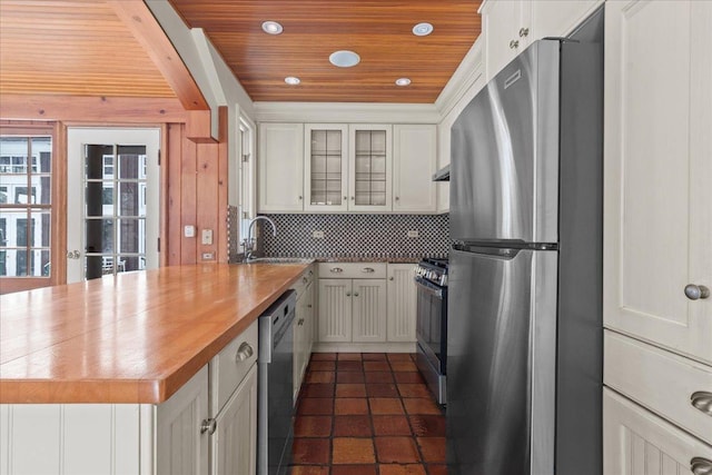 kitchen with stainless steel appliances, wood counters, white cabinets, wooden ceiling, and sink