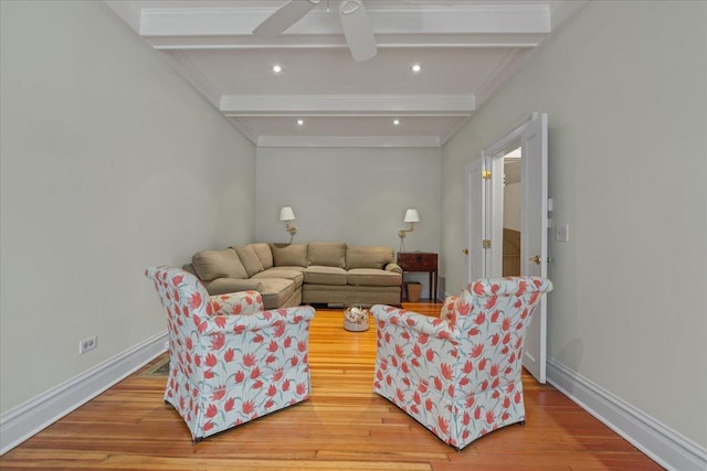 living room with light hardwood / wood-style floors and beamed ceiling