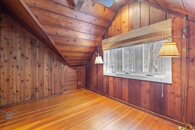 bonus room with vaulted ceiling, wooden walls, light hardwood / wood-style floors, ceiling fan, and wooden ceiling