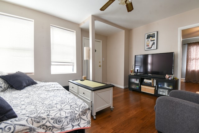 bedroom with dark hardwood / wood-style floors, multiple windows, and ceiling fan