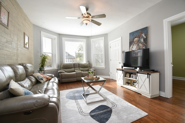 living room with ceiling fan and dark wood-type flooring