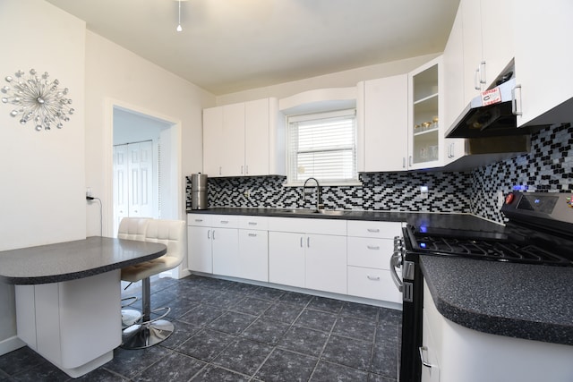 kitchen featuring sink, decorative backsplash, a kitchen bar, white cabinetry, and range with gas cooktop