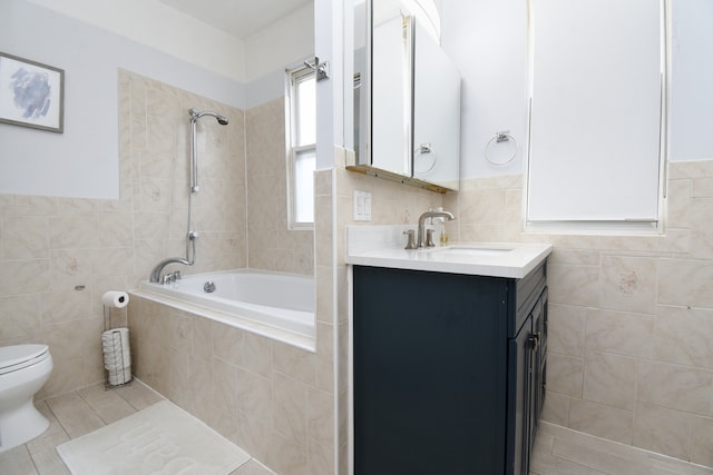 full bathroom with tile patterned floors, vanity, toilet, and tile walls