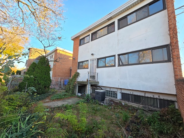 rear view of house with central air condition unit