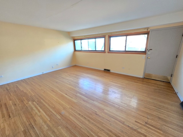 unfurnished room with light wood-type flooring