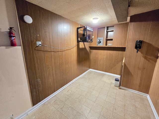 laundry room featuring wood walls