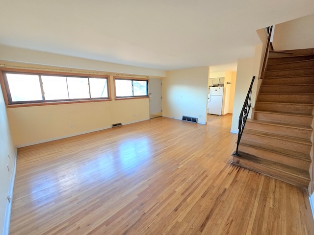 unfurnished living room with light wood-type flooring